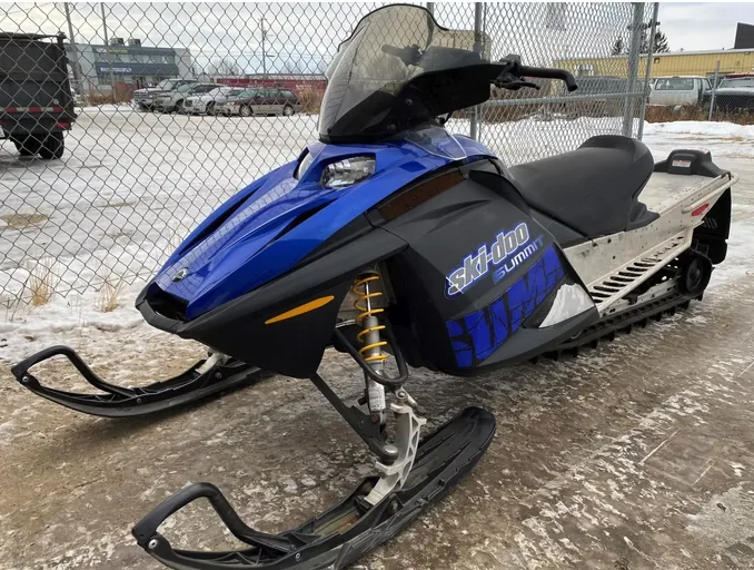 Blue Ski-Doo snowmobile parked outside